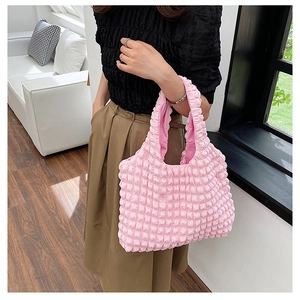 Detail of pink bubble texture tote bag showing pleated popcorn fabric and soft handle