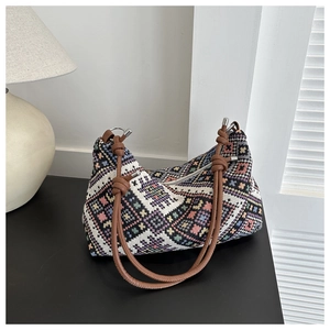 Detail view of ethnic jacquard canvas tote with geometric patterns and leather straps
