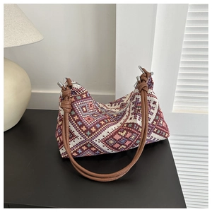 Detailed shot of ethnic jacquard canvas tote with geometric patterns and leather strap