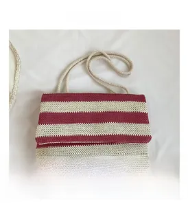 Detailed macro view of red and beige striped woven tote bag with a thick rope shoulder strap