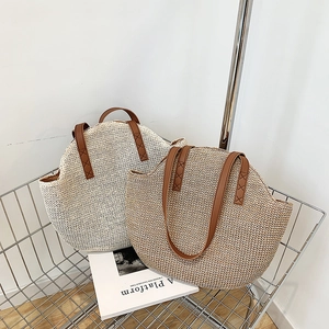 Summer woven straw tote bags in beige and natural colors with brown leather handles