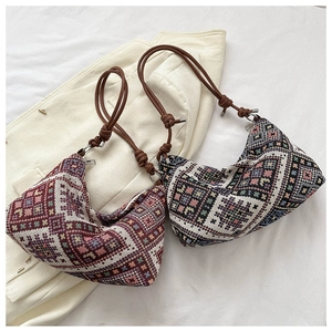 Detail of bohemian geometric woven fabric texture and brown leather knot shoulder straps