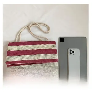 Top-down view of striped woven tote bag compared with an iPad to show its large capacity