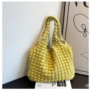 Close-up of yellow popcorn texture tote bag with tactile 3D bubble pleated fabric finish
