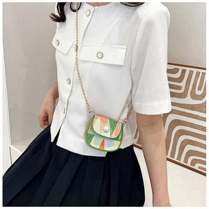 Detail of mini crossbody bag with color-block geometric pattern and gold chain strap