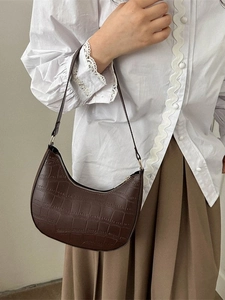 Brown crocodile embossed crescent shoulder bag for women with elegant minimalist design