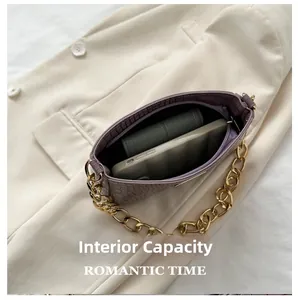 Detail view of purple crocodile texture crossbody bag showing spacious interior capacity