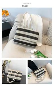 Detail view of the black and white striped woven tote bag with white rope straps