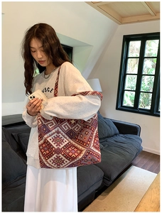 Ethnic style woven tote bag with colorful geometric patterns and wide shoulder straps