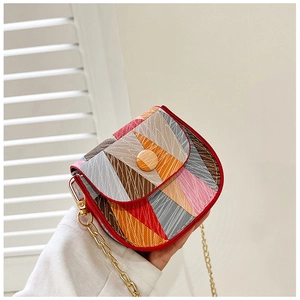 Detail of mini crossbody bag with color-block geometry and golden chain strap