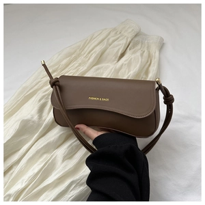 Close-up of brown faux leather bag with gold Fashion & Bags logo and slim shoulder strap