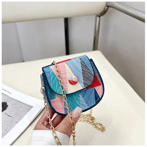 Close-up of geometric multi-color flap bag with golden chain strap and round buckle