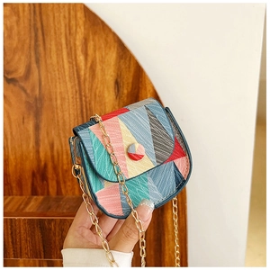Detailed view of colorful geometric patchwork on a mini crossbody bag with gold chain strap