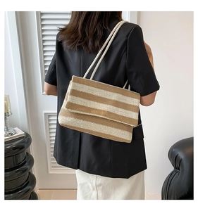 Close-up of a striped woven tote bag with khaki and cream patterns for summer