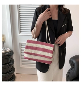 Detail of a large woven tote bag with red and white stripes and dual rope straps