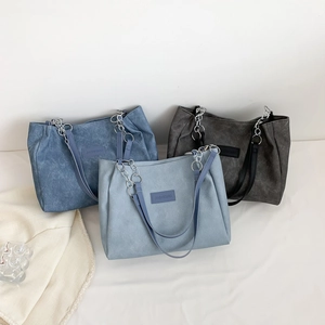 Three minimalist large-capacity denim tote bags in blue, light blue, and charcoal grey
