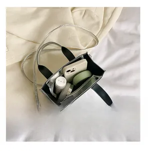 Top view of silver metallic mini tote bag showing internal storage for cosmetics