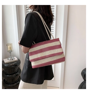Detail view of the bohemian striped woven tote bag with cotton rope handle on shoulder