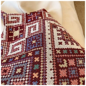 Macro shot of colorful ethnic geometric embroidery on high-density jacquard fabric