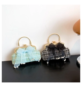 Detail of tweed evening bags with large mesh bows, pearl trim, and gold metal handles