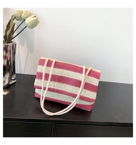 Detailed texture of red and white striped woven tote bag with cotton rope handles
