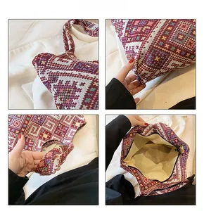 Detail view of ethnic woven pattern texture and secure zipper closure on tote bag