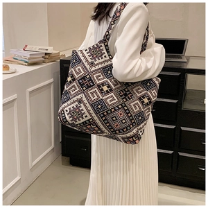 Detail of bohemian tote bag featuring colorful geometric patterns and soft shoulder strap