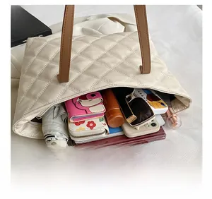 Interior view showing large storage capacity of quilted tote bag with daily essentials