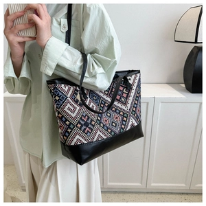 Macro detail of bohemian patterned large tote bag featuring premium leather handles