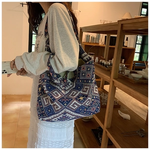 Close-up of geometric woven pattern on ethnic style shoulder bag with sturdy knit texture