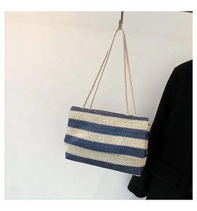 Detail of blue and white striped woven tote bag with nautical rope shoulder strap style