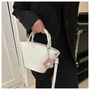 White bucket bag with flower charm and Fashion & Bag text logo for daily commute