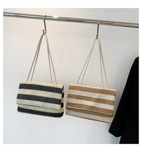 Detail of hand-woven striped tote bags featuring textured patterns and knotted rope straps