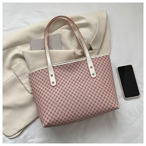 Detailed close-up of pink geometric tote bag with white leather handles and red edge paint