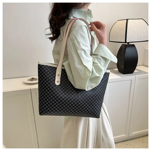 Detail view of large tote bag with grey geometric dot pattern and red edge finishing