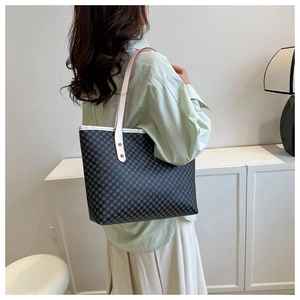 Detailed side view of large tote bag with geometric pattern and white leather trim