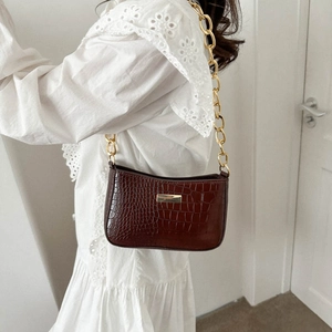 Brown crocodile pattern shoulder bag with a bold gold chain strap and metal hardware