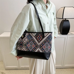 Ethnic style tote bag with colorful geometric jacquard weaving and black leather base