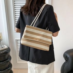 Minimalist khaki and beige striped woven tote bag shown on model for daily casual style