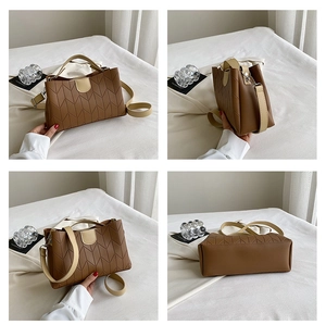 Detail of a brown PU tote bag with V-shaped geometric texture and cream contrast straps