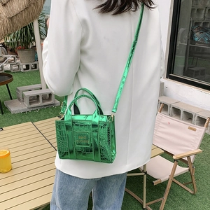 Glossy bright green crocodile pattern mini crossbody handbag with a sleek metallic finish