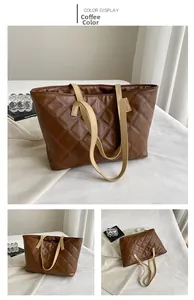 Detail view of large coffee tote bag with quilted pattern and contrast handles
