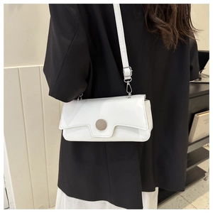 Minimalist white rectangular crossbody bag shown on model with adjustable strap