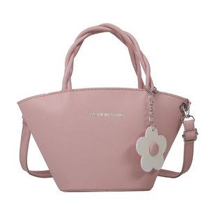 Pink minimalist basket bag with woven handles, daisy charm and detachable shoulder strap