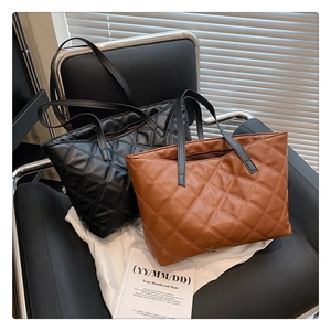 Detail showing high-quality diamond quilted texture on black and brown tote bags
