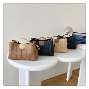 Chic chevron quilted tote bags in four colors arranged on a modern office desk