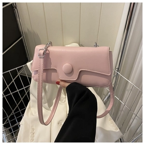 Detailed close-up of a pink PU leather minimalist baguette bag with circular buckle