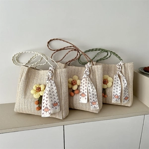 Straw tote bag with yellow flowers, fringe tassels and printed silk scarf handle detail