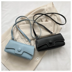 Close-up of minimalist rectangular baguette bags with geometric flap and matte leather