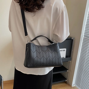 Classic black V-quilted faux leather tote bag with top handle and silver hardware